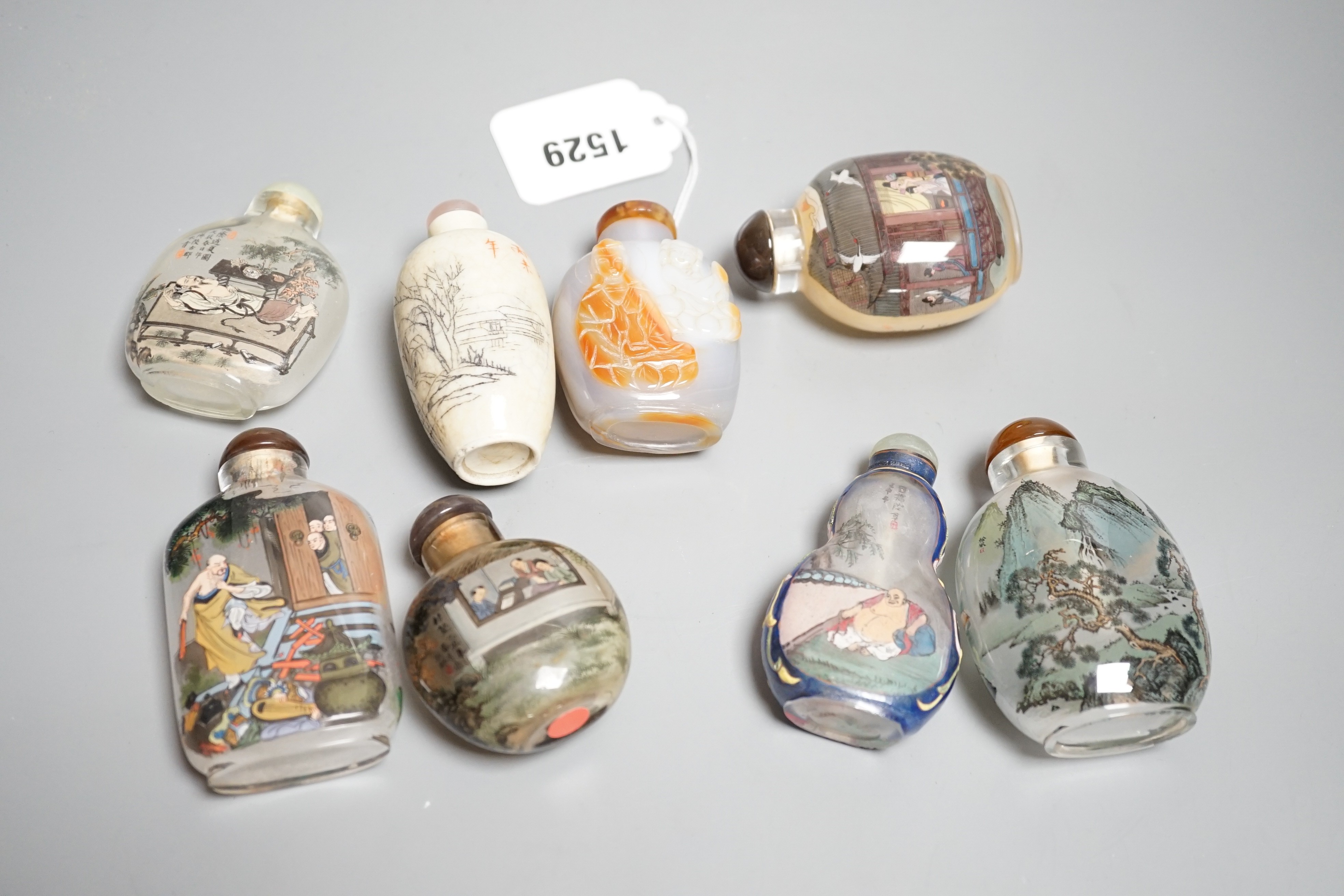 Six Chinese inside painted glass snuff bottles, an agate cameo snuff bottle and an incised crackle glaze snuff bottle, tallest 9cm